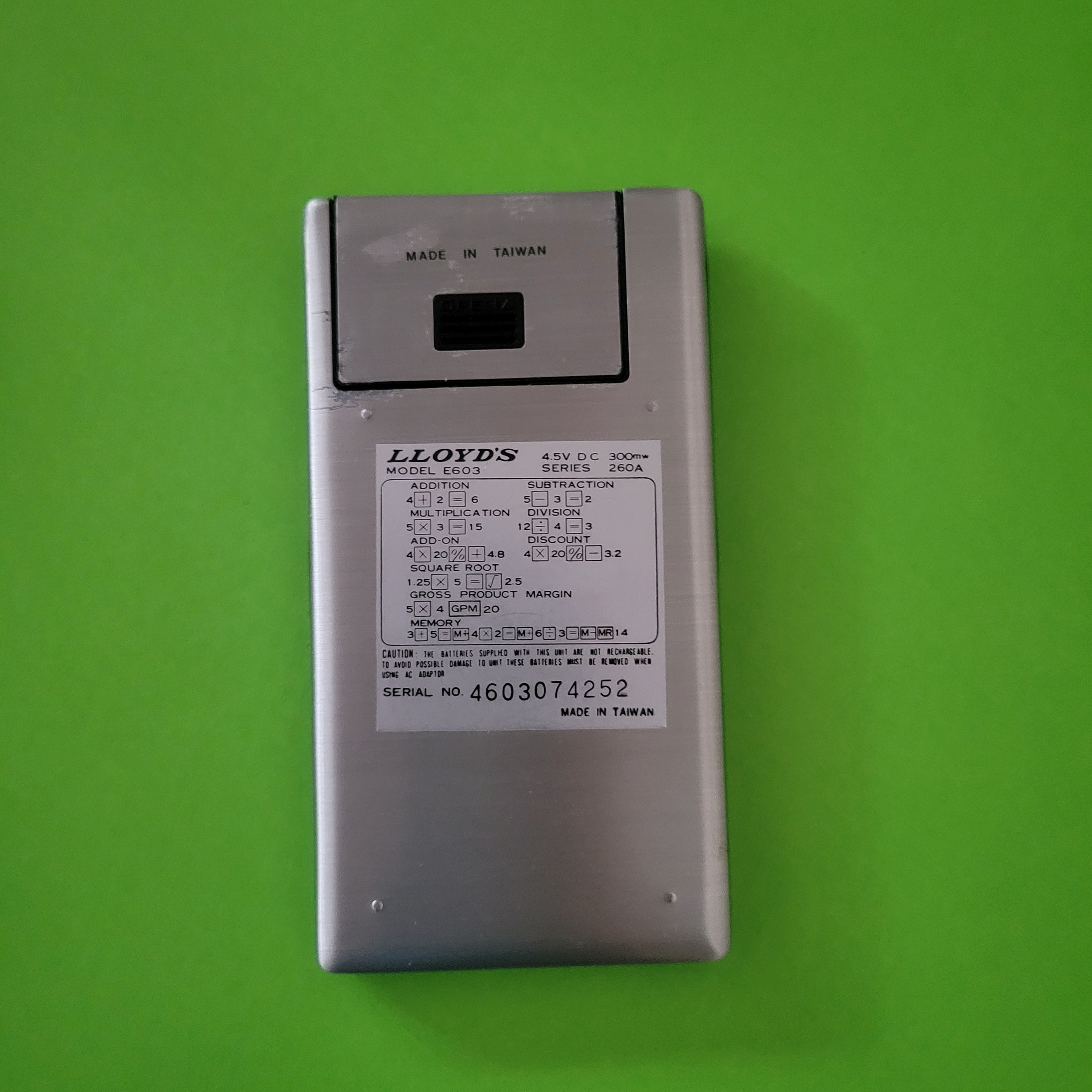 An image of the back of a Lloyd's Accumatic 603 four function plus calulator